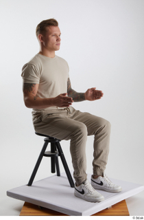Gilbert 1 casual dressed grey t-shirt grey trousers kneeling sitting…